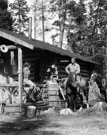 simsearch:846-02793153,k - 1920s - 1930s COUPLE IN FRONT OF LOG CABIN WOMAN SITTING ON PORCH RAILING MAN ON HORSE ALBERTA CANADA Stock Photo - Rights-Managed, Code: 846-05646212