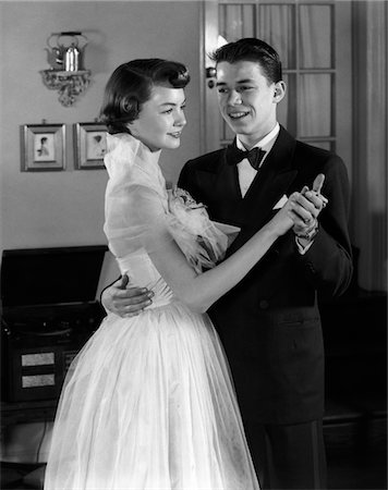 simsearch:846-02791806,k - 1950s SMILING TEENAGE COUPLE IN FORMAL EVENING WEAR DANCING INDOORS Stock Photo - Rights-Managed, Code: 846-05646277