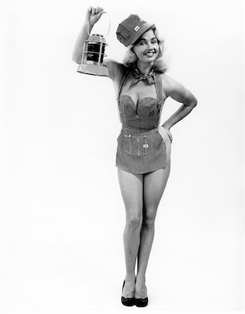security costume - 1950s FULL LENGTH PORTRAIT OF BLOND WOMAN DRESSED IN RAILROAD APRON & CAP HOLDING SIGNAL LAMP PINUP Stock Photo - Rights-Managed, Code: 846-05646406