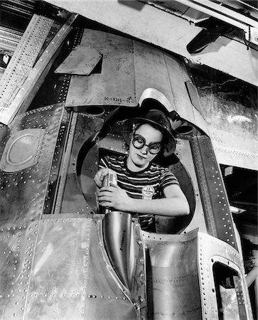 simsearch:846-05645846,k - 1940s WOMAN RIVETER DRILLING A HOLE IN A B-17 BOMBER ENGINE Foto de stock - Con derechos protegidos, Código: 846-05646470