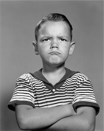 simsearch:846-08030391,k - 1960s PORTRAIT POUTING ANGRY BOY ARMS FOLDED AGAINST CHEST STRIPED SHIRT Stock Photo - Rights-Managed, Code: 846-05646483