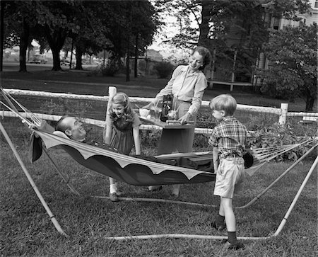 family on hammock - 1950s MOM & KIDS SERVING DAD IN HAMMOCK Stock Photo - Rights-Managed, Code: 846-05646508