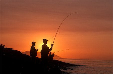 1990s SILHOUETTE OF THREE MEN AND DOG SURF FISHING Stock Photo - Rights-Managed, Code: 846-05646621
