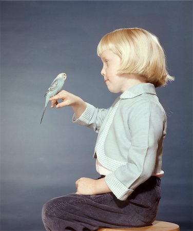 1950s - 1960s BLOND GIRL WITH PET BIRD PARAKEET ON HER FINGER Stock Photo - Rights-Managed, Code: 846-05646640