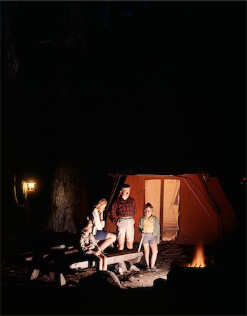 1960s NIGHT SCENE FAMILY GAZING INTO CAMPFIRE BY TENT Stock Photo - Rights-Managed, Code: 846-05646752