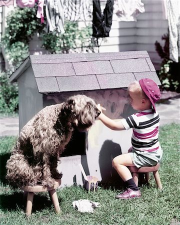 1950s LITTLE BOY PAINTING DOGHOUSE SHAGGY DOG ON STOOL WATCHING Stock Photo - Rights-Managed, Code: 846-05646822