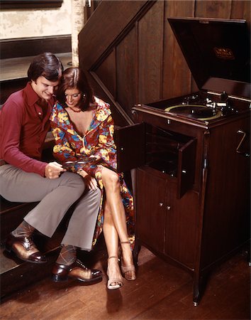 simsearch:846-03165791,k - COUPLE SITTING CLOSE TOGETHER LISTENING TO AUDIO RECORD PLAYER HUSBAND WIFE INDOOR 1970s Stock Photo - Rights-Managed, Code: 846-05647223