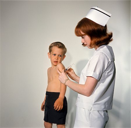 1960s WOMAN NURSE GIVING INOCULATION NEEDLE TO FRIGHTENED LITTLE BOY Stock Photo - Rights-Managed, Code: 846-05647268