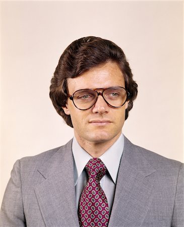 1970s MAN PORTRAIT BUSINESS SUIT SERIOUS EXPRESSION AVIATOR EYEGLASSES FASHION Stock Photo - Rights-Managed, Code: 846-05647296