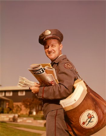 postal letters images - 1960s SMILING MAILMAN HOLDING MAIL MAILBAG LETTERS LEATHER MAILBAG IN SUBURBAN NEIGHBORHOOD Stock Photo - Rights-Managed, Code: 846-05647313