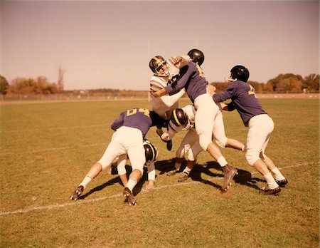 simsearch:846-05647924,k - 1960s SIX FOOTBALL PLAYERS RUNNING BLOCKING TACKLING ON SCRIMMAGE FIELD Stock Photo - Rights-Managed, Code: 846-05647437