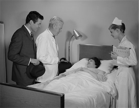 simsearch:846-05645854,k - 1960s DOCTOR NURSE HUSBAND TALKING WITH FEMALE PATIENT IN HOSPITAL BED Stock Photo - Rights-Managed, Code: 846-05647696