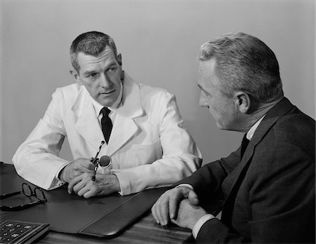 simsearch:846-05647696,k - 1950s DOCTOR SITTING AT DESK TALKING TO MALE PATIENT Stock Photo - Rights-Managed, Code: 846-05647711