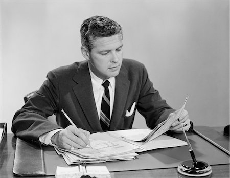 simsearch:846-02795767,k - 1950s - 1960s BUSINESSMAN AT DESK LOOKING OVER FILES PAPERS MAKING NOTES WITH PENCIL Stock Photo - Rights-Managed, Code: 846-05647731