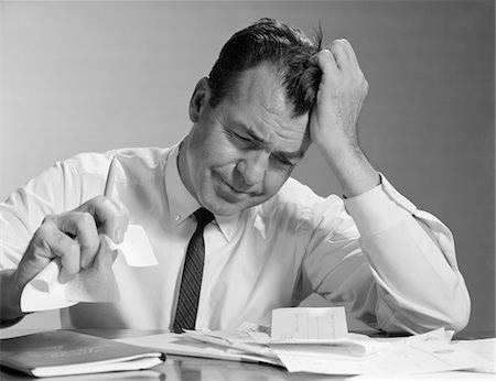 simsearch:846-08030391,k - 1960s FRUSTRATED BUSINESSMAN HAND TO FOREHEAD CRUMPLING PAPER IN HAND Stock Photo - Rights-Managed, Code: 846-05647749