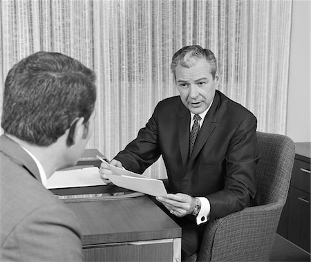 simsearch:846-05648290,k - 1960s - 1970s MAN FROM BEHIND MEETING AT DESK OF OLDER BUSINESSMAN Stock Photo - Rights-Managed, Code: 846-05647761