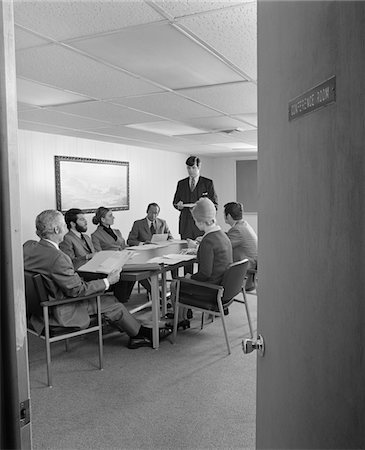 simsearch:846-05648290,k - 1970s GROUP 7 EXECUTIVE BUSINESS PEOPLE  CONFERENCE TABLE VIEWED THROUGH OPEN DOOR Stock Photo - Rights-Managed, Code: 846-05647774