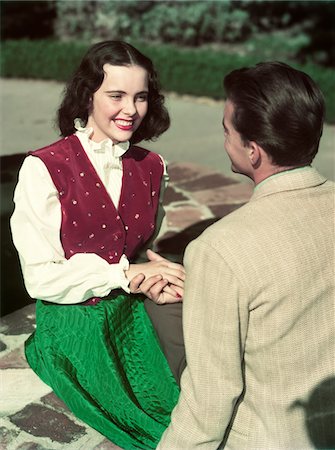 romantic old fashioned women clothes - 1940s - 1950s SMILING TEEN COUPLE SITTING BY WELL HOLDING HANDS Stock Photo - Rights-Managed, Code: 846-05647871