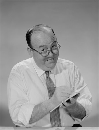 simsearch:846-02796457,k - 1950s - 1960s BALDING BUSINESSMAN WEARING EYEGLASSES SHIRT SLEEVES SMILING WRITING NOTEPAD Stock Photo - Rights-Managed, Code: 846-05647917