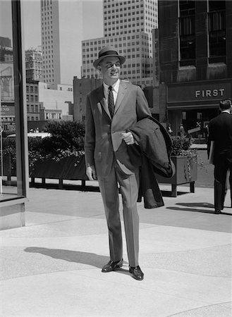 simsearch:846-07200135,k - 1950s - 1960s BUSINESSMAN WEARING SUIT HAT CARRYING TOP COAT STANDING ON CITY STREET Stock Photo - Rights-Managed, Code: 846-05647923