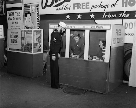 stamp - 1940s - 1943 SAILOR BUYING WAR STAMPS AT DONUT MOBILE AT BOWLING GREEN NEW YORK CITY Stock Photo - Rights-Managed, Code: 846-05647984