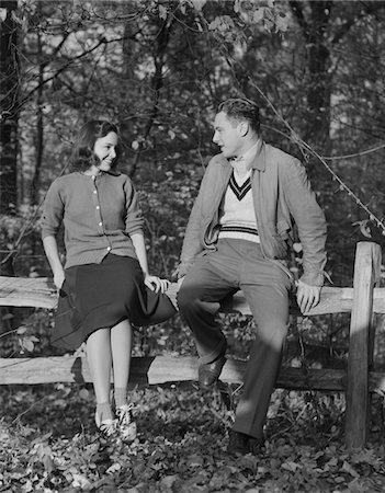 simsearch:846-02793798,k - 1940s YOUNG COUPLE SITTING ON FENCE AUTUMN SMILING AT ONE ANOTHER Stock Photo - Rights-Managed, Code: 846-05648094