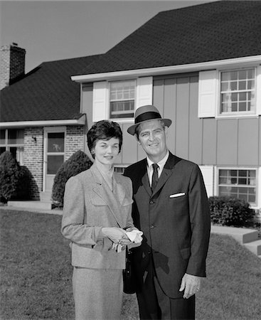 simsearch:846-05648112,k - 1960s COUPLE SMILING MAN AND WOMAN STANDING BEFORE SUBURBAN HOUSE Stock Photo - Rights-Managed, Code: 846-05648136