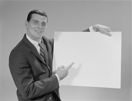 simsearch:846-05648290,k - 1960s SMILING MAN POINTING TO BLANK POSTER Stock Photo - Rights-Managed, Code: 846-05648179