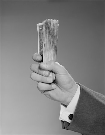 1960s MALE  HAND HOLDING A FISTFUL DOLLARS CASH MONEY Stock Photo - Rights-Managed, Code: 846-05648186