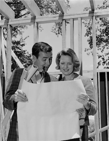 simsearch:846-05648112,k - 1960s COUPLE LOOKING AT HOUSE PLANS BLUEPRINTS MAN SMOKING PIPE Stock Photo - Rights-Managed, Code: 846-05648218