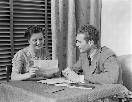 1930s COUPLE MAN WOMAN SITTING AT TABLE GOING OVER PAPERS Stock Photo - Rights-Managed, Code: 846-05648230