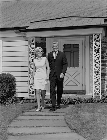 1960s MATURE COUPLE WALKING  ON SIDEWALK FRONT OF HOUSE Stock Photo - Rights-Managed, Code: 846-05648253