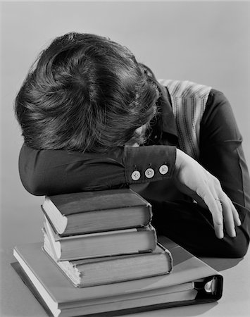 1970s FEMALE STUDENT HEAD RESTING ON STACK OF BOOKS SLEEPING Stock Photo - Rights-Managed, Code: 846-05648275