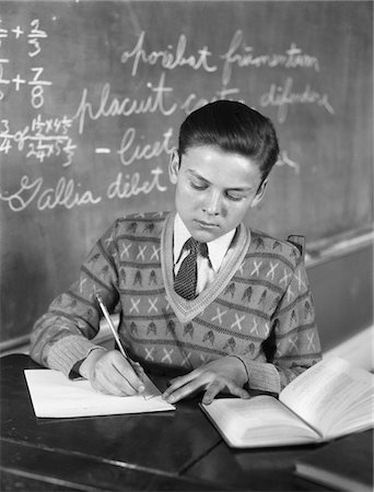 simsearch:846-02796457,k - 1920s - 1930s BOY VEE NECK SWEATER WRITING AT SCHOOL DESK Stock Photo - Rights-Managed, Code: 846-05648294