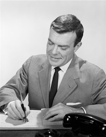 simsearch:846-02796457,k - 1950s - 1960s SMILING BUSINESSMAN AT DESK WRITING CHECKS Stock Photo - Rights-Managed, Code: 846-05648306