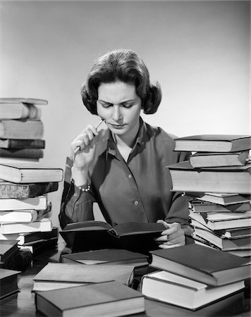 simsearch:846-05646032,k - 1950s - 1960s COLLEGE WOMAN STUDYING SURROUNDED ALL AROUND BY PILES OF BOOKS Stock Photo - Rights-Managed, Code: 846-05648317