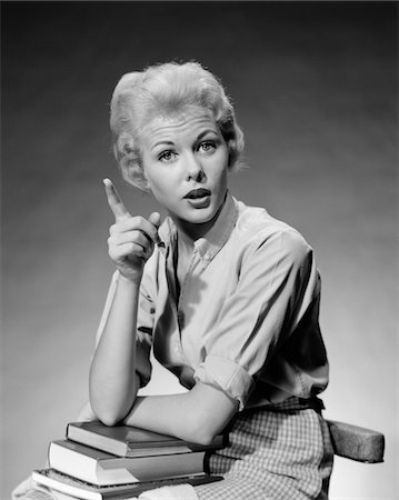 1950s - 1960s BLOND WOMAN STACK OF BOOKS IN HER LAP SHAKING FINGER POINTING Stock Photo - Rights-Managed, Code: 846-05648346