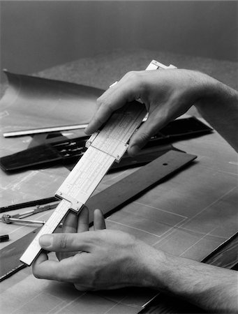 1930s MAN'S HANDS USING SLIDE RULE OVER DRAFTING TABLE Stock Photo - Rights-Managed, Code: 846-05648388