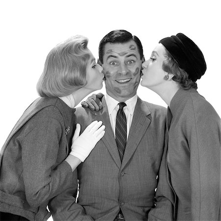 simsearch:846-05646226,k - 1950s MAN SMILING FACE COVERED WITH LIPSTICK KISS MARKS AFTER BEING KISSED BY TWO WOMEN FROM BOTH SIDES Stock Photo - Rights-Managed, Code: 846-05648424