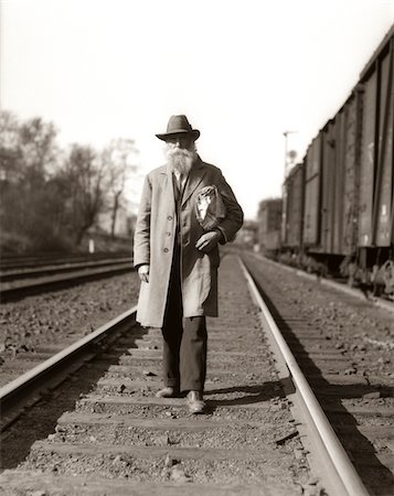simsearch:846-02796653,k - 1930s GREAT DEPRESSION ERA MAN HOMELESS HOBO WALKING DOWN RAILROAD TRACKS Stock Photo - Rights-Managed, Code: 846-05648510