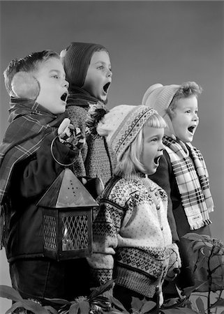 simsearch:846-05648541,k - 1950s FOUR CHILDREN TWO BOYS TWO GIRLS SINGING CHRISTMAS CAROL TOGETHER HOLDING CANDLE LANTERN Stock Photo - Rights-Managed, Code: 846-05648534