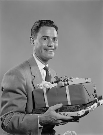 simsearch:846-05648541,k - 1950s SMILING MAN HOLDING WRAPPED CHRISTMAS PRESENTS Stock Photo - Rights-Managed, Code: 846-05648554