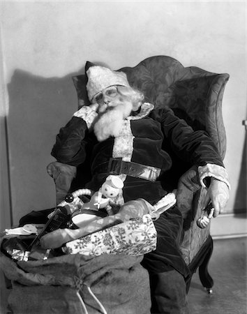 simsearch:846-05647602,k - 1920s - 1930s SANTA CLAUS ASLEEP IN ARMCHAIR WITH BAG SACK OF TOYS Stock Photo - Rights-Managed, Code: 846-05648558