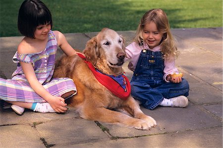 1990s TWO LITTLE GIRLS SITTING WITH THEIR DOG Stock Photo - Rights-Managed, Code: 846-06111741