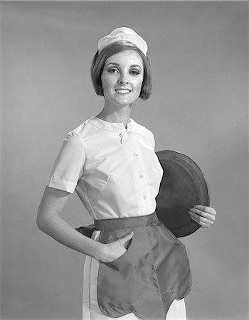 simsearch:846-05646032,k - 1960s PORTRAIT SMILING WAITRESS IN UNIFORM APRON AND HAT HOLDING ROUND SERVING TRAY UNDER ARM LOOKING AT CAMERA Stock Photo - Rights-Managed, Code: 846-06111778