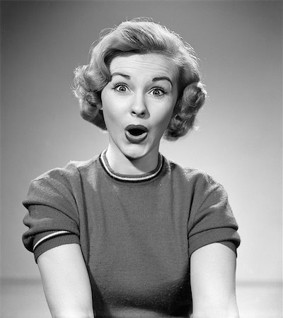 1950s HEAD SHOT OF WOMAN EYES AND MOUTH WIDE OPEN SURPRISED EXPRESSION INDOOR LOOKING AT CAMERA Stock Photo - Rights-Managed, Code: 846-06111846