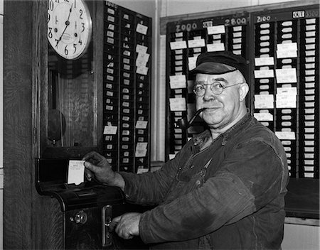 simsearch:846-02795908,k - 1930s ELDERLY FACTORY WORKER IN OVERALLS SMOKING PIPE PUNCHING TIME CARD Stock Photo - Rights-Managed, Code: 846-06111912