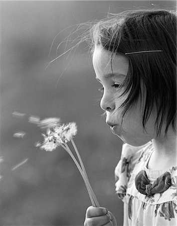 simsearch:846-02796653,k - 1970s CLOSE-UP SIDE VIEW OF GIRL BLOWING AWAY SEEDS OF DANDELION Stock Photo - Rights-Managed, Code: 846-06111933
