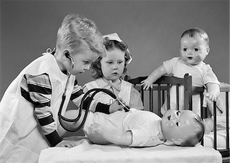 simsearch:846-05647696,k - 1950s BOY AND GIRL PLAYING DOCTOR AND NURSE WITH STETHOSCOPE AND DOLLS Stock Photo - Rights-Managed, Code: 846-06111956