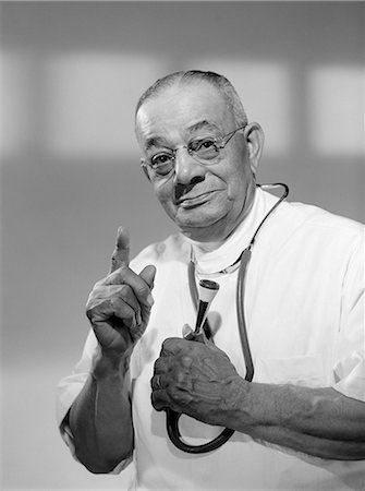 simsearch:846-05648290,k - 1960s PORTRAIT OF MAN DOCTOR HOLDING STETHOSCOPE AND ADMONISHING WITH A RAISED FINGER LOOKING AT CAMERA Stock Photo - Rights-Managed, Code: 846-06112189